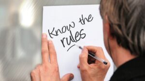 Hand writing "know the rules" on paper; representing the SECURE Act
